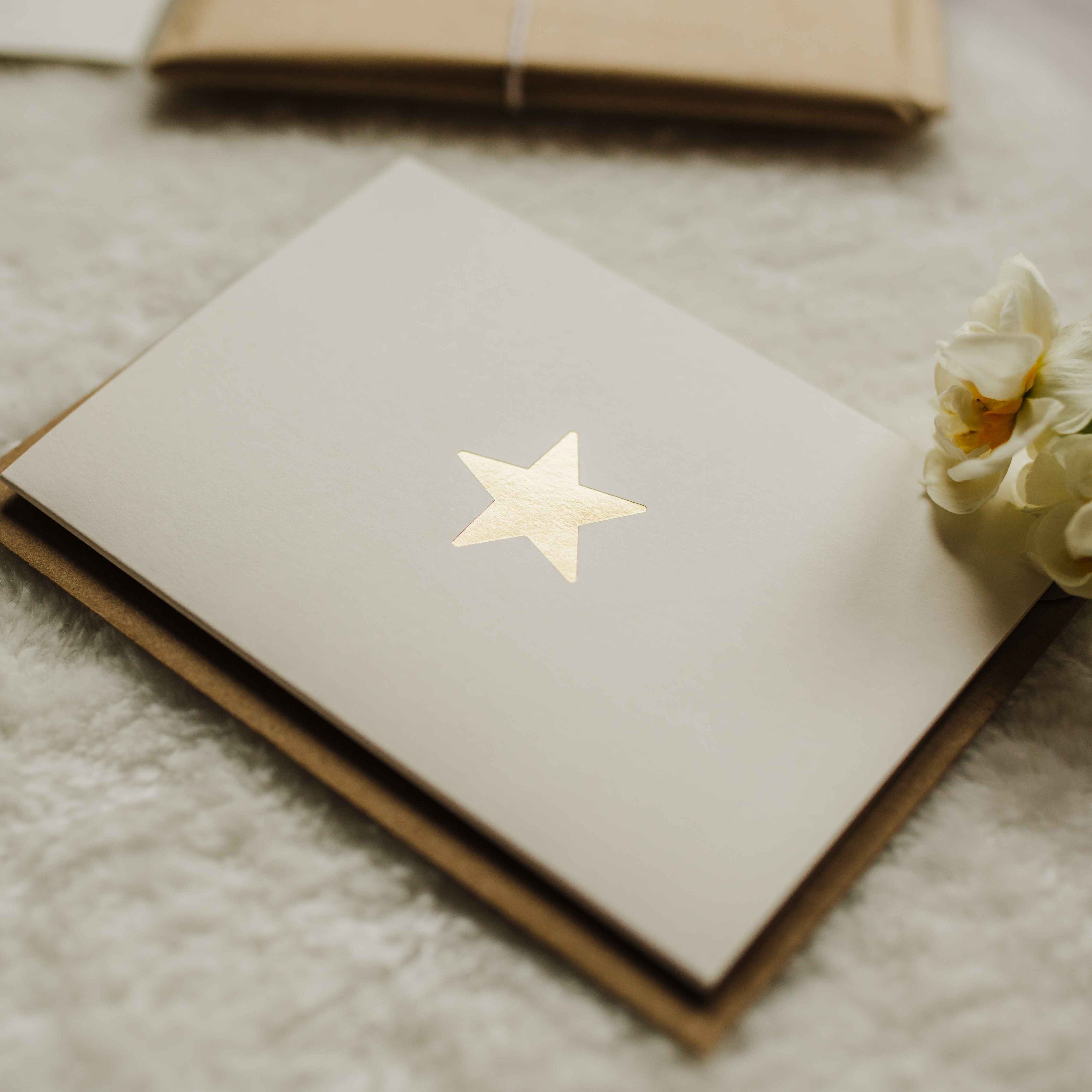 Cream card with gold embossed star