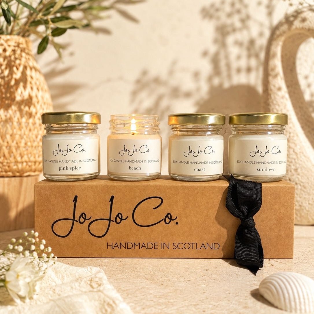 JoJo Co. Limited Edition Summer Mini Candle Gift Set with four luxury mini soy wax candles in Pink Spice, Beach, Coast and Sundown fragrances, presented in a branded gift box.