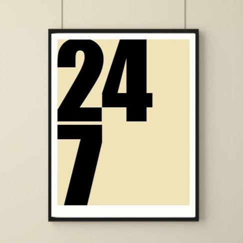 A simple art print with solid cream background and the numbers 24/7 on display