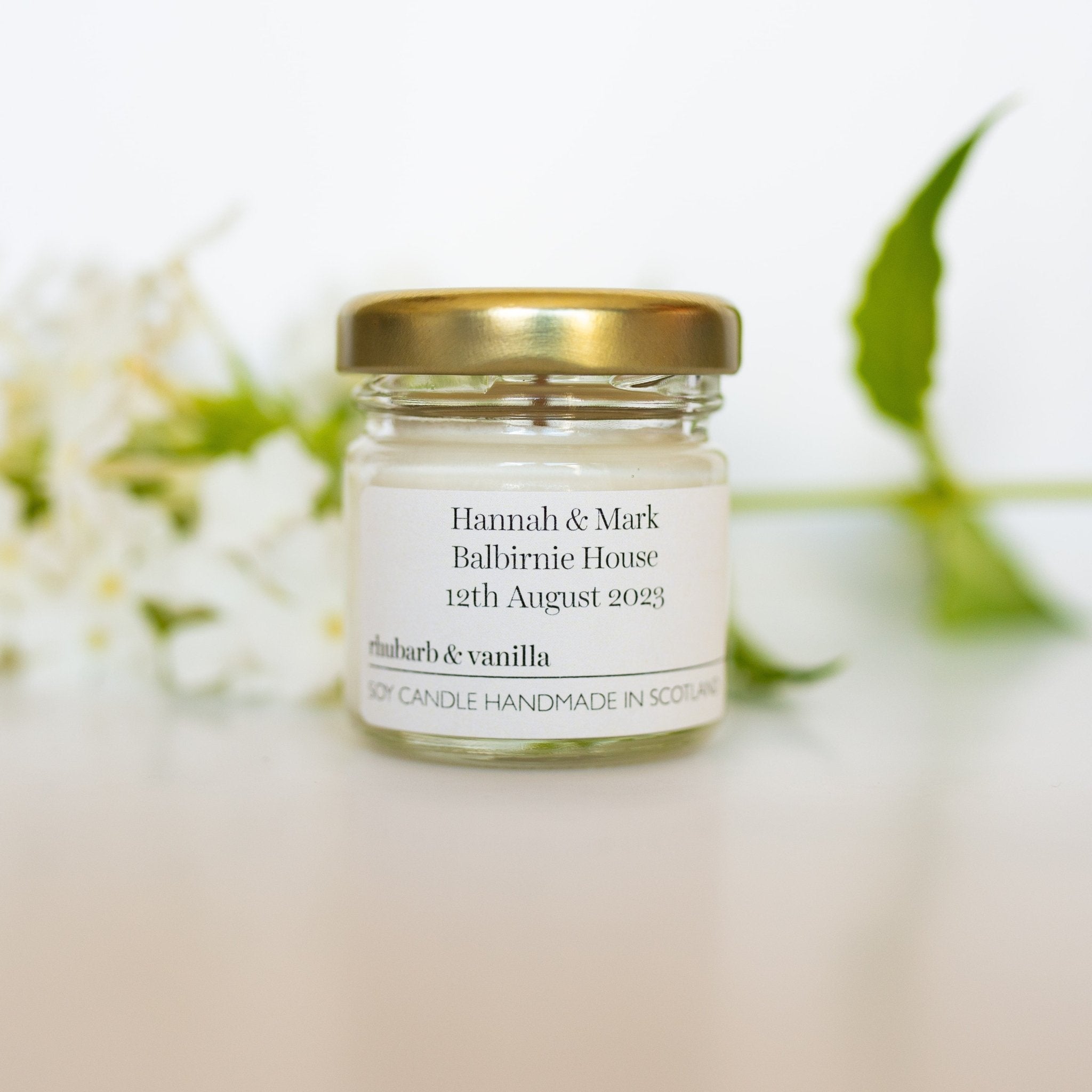 Close up of JoJo Co. mini soy wax candle with gold lid, wedding favour